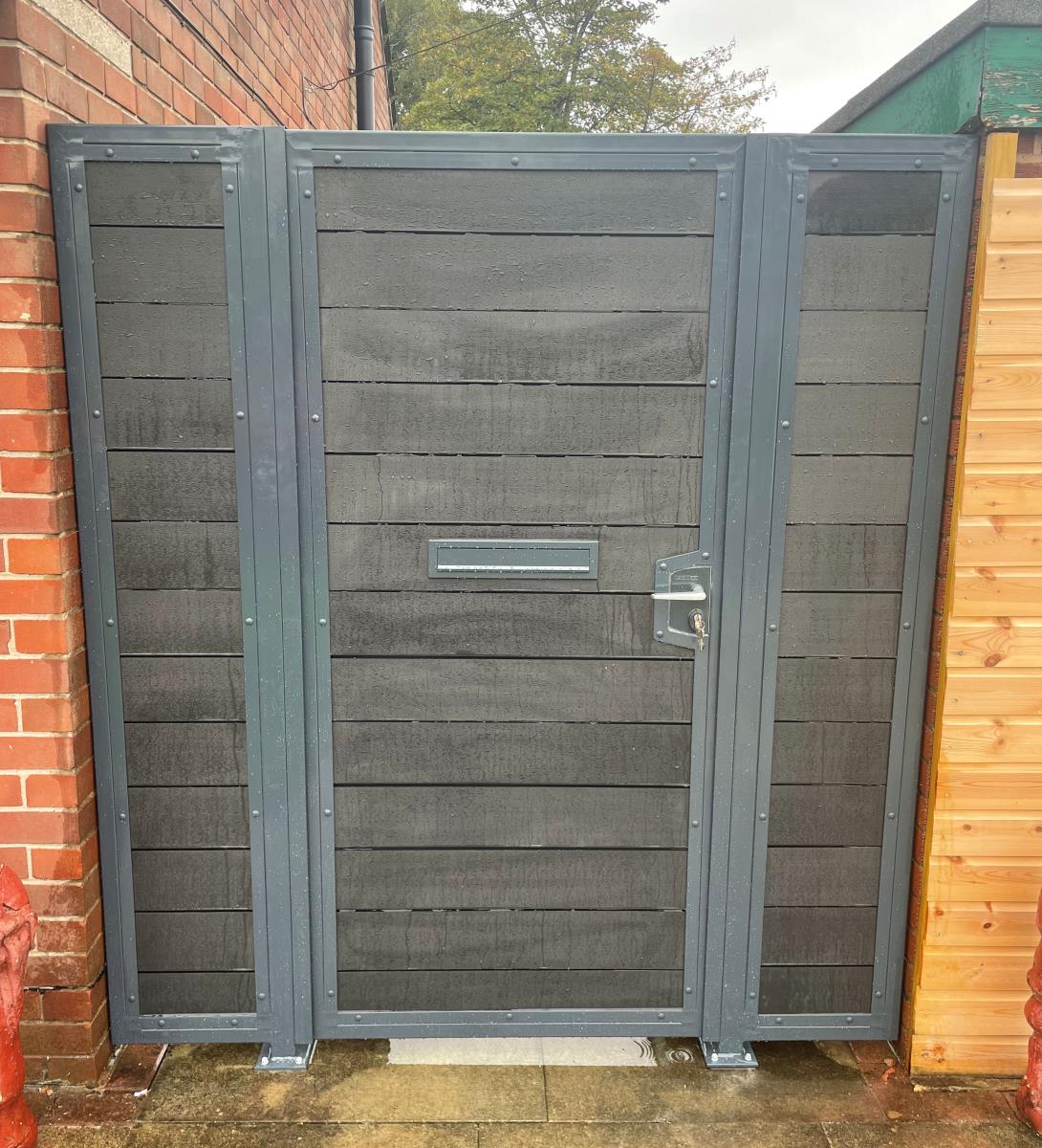 Charcoal black composite infill inside anthracite grey frame gates for a property in Leyland.