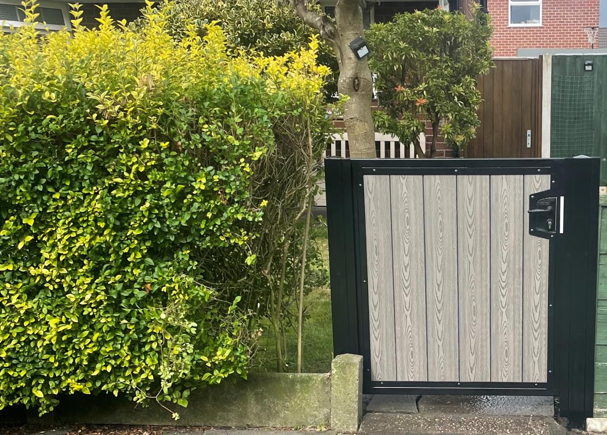 Black steel frame with ash wood effect composite infill gate fitted in Lowton, Greater Manchester.