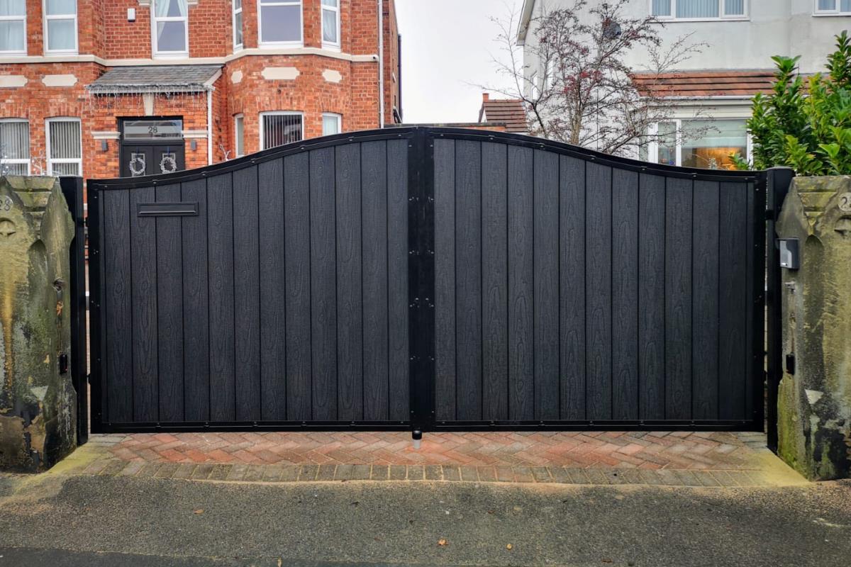 Bespoke arch top black embossed composite electric gates fitted in Southport in Merseyside.