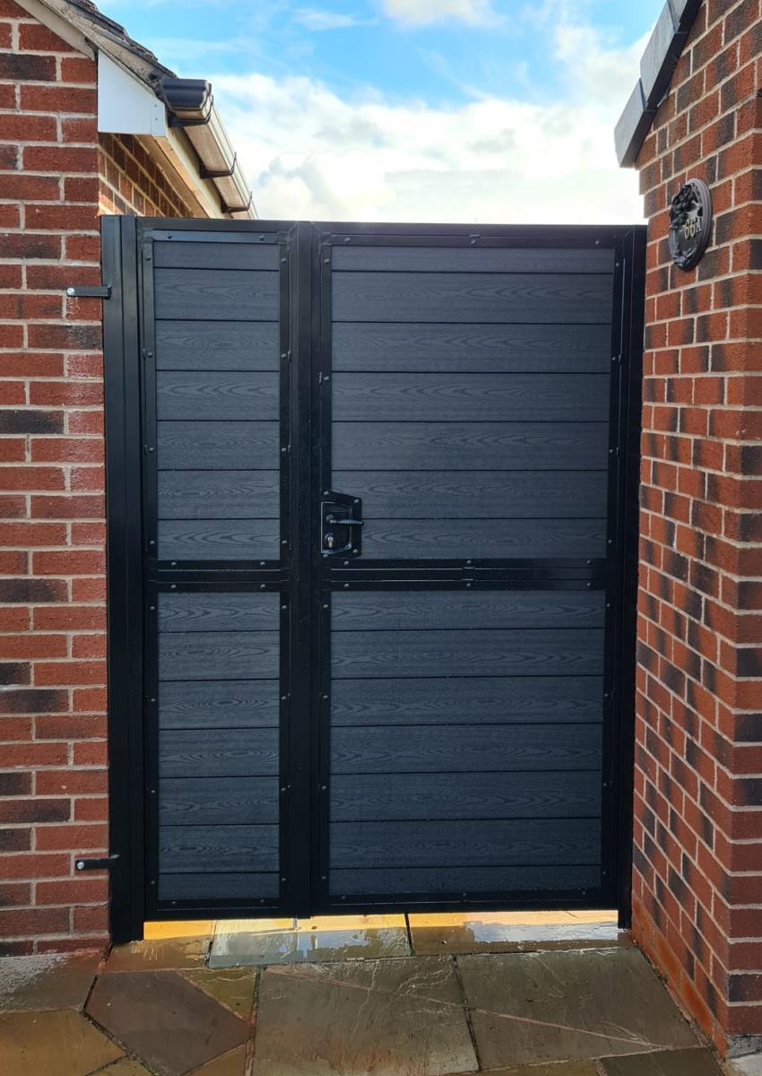 Black composite gate in steel frame with wood effect embossed infill fitted in Skelmersdale, Lancashire.