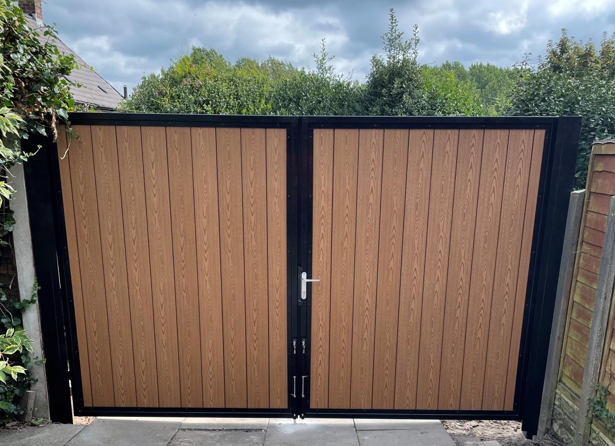 Double driveway composite gates in golden oak fitted in the Manchester area.