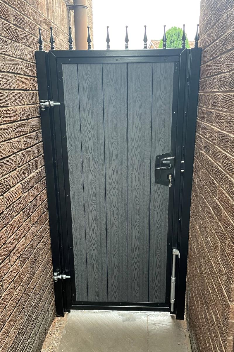 Black framed composite gate with grey woodgrain timber infill effect fitted in the Liverpool area.