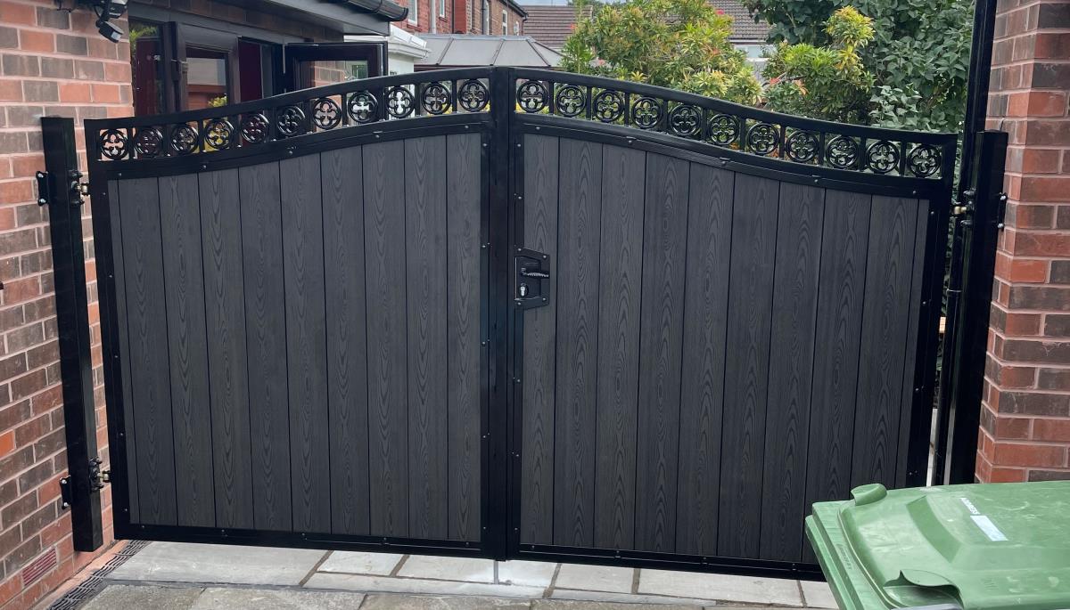 Black ornate arch top gates with black embossed composite infill fitted in Warrington area.