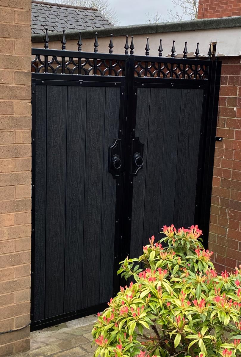 Ornate driveway gates with a black embossed composite infill for a Warrington home.