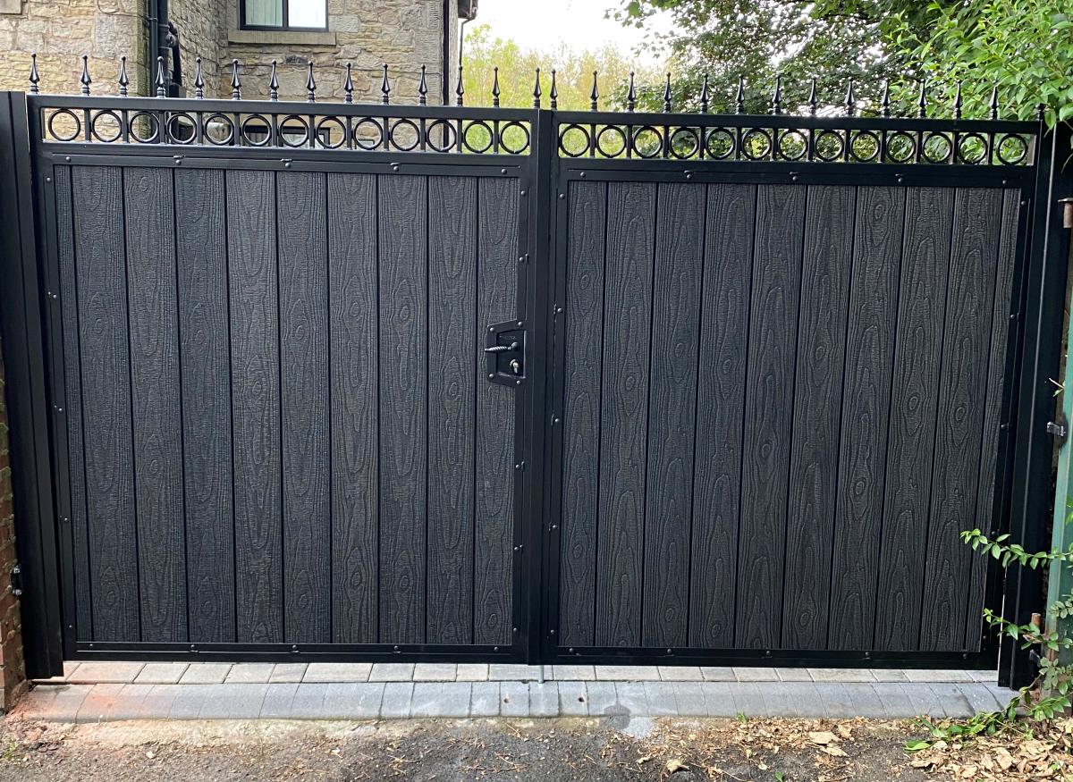 Double ornate driveway gates with embossed black composite fitted in the Macclesfield area.