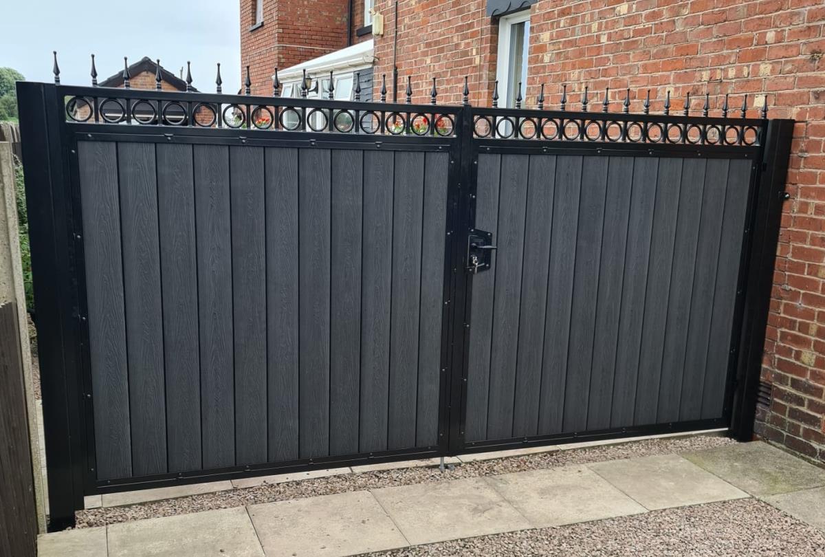 Ornate steel gates with black timber embossed composite infill fitted for a Chorley property.