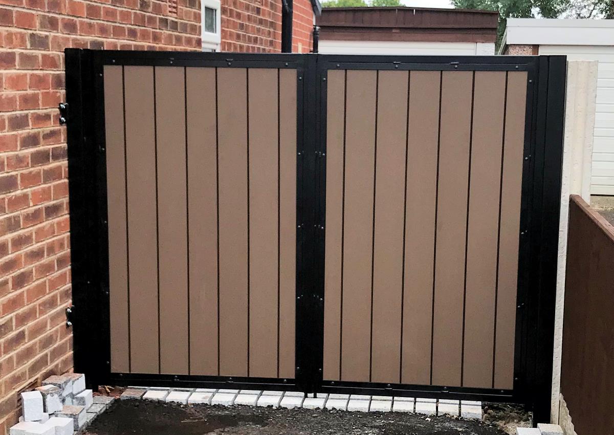 Composite driveway gates installation in the Chorley area in light smooth infill effect.