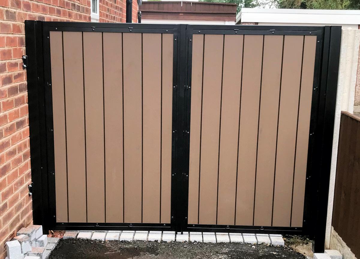 Installation of driveway gates in the Lancaster area with a light, smooth, composite infill.
