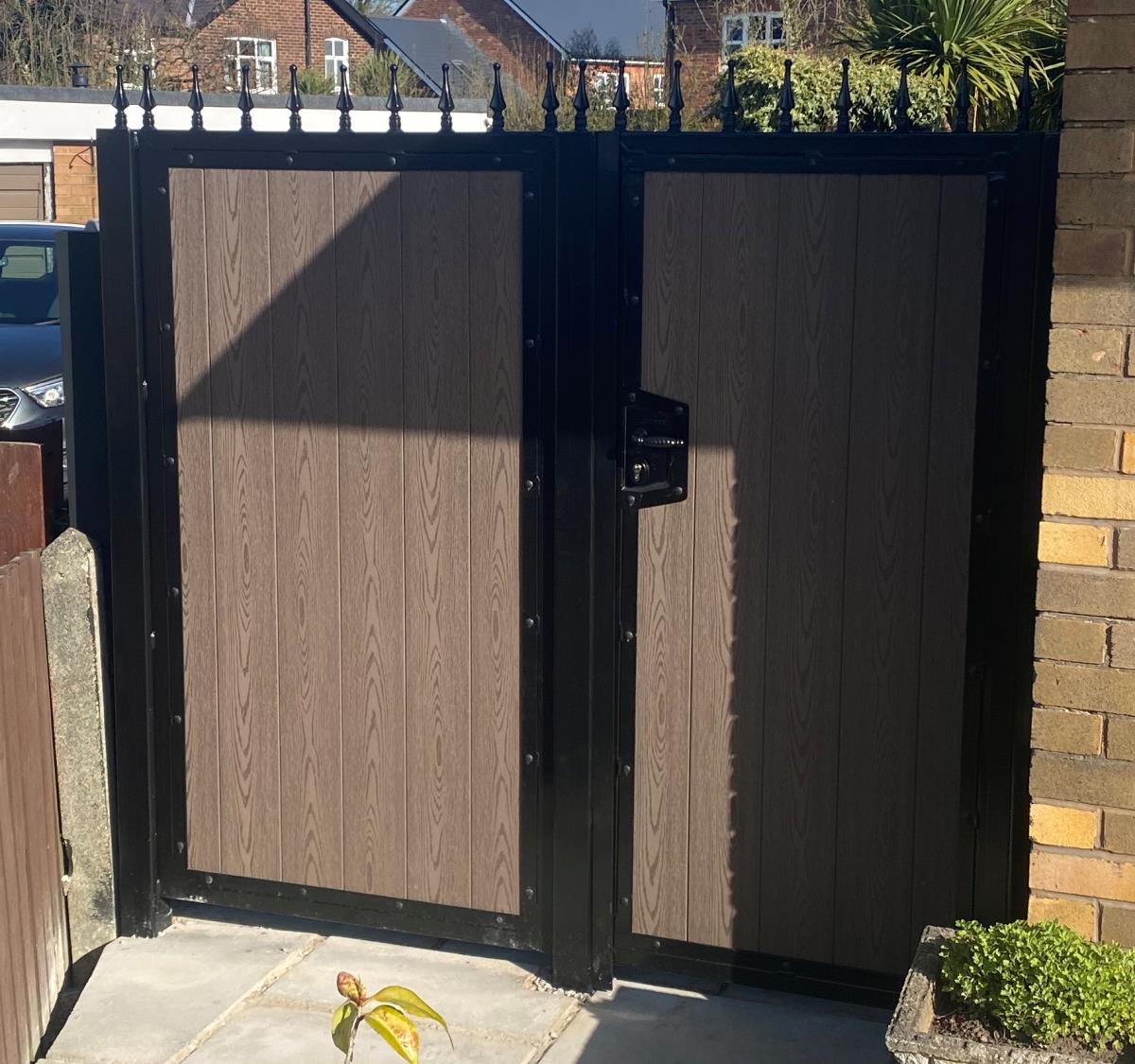 Side gate and panel with a brown timber effect embossed composite infill in Chorley.