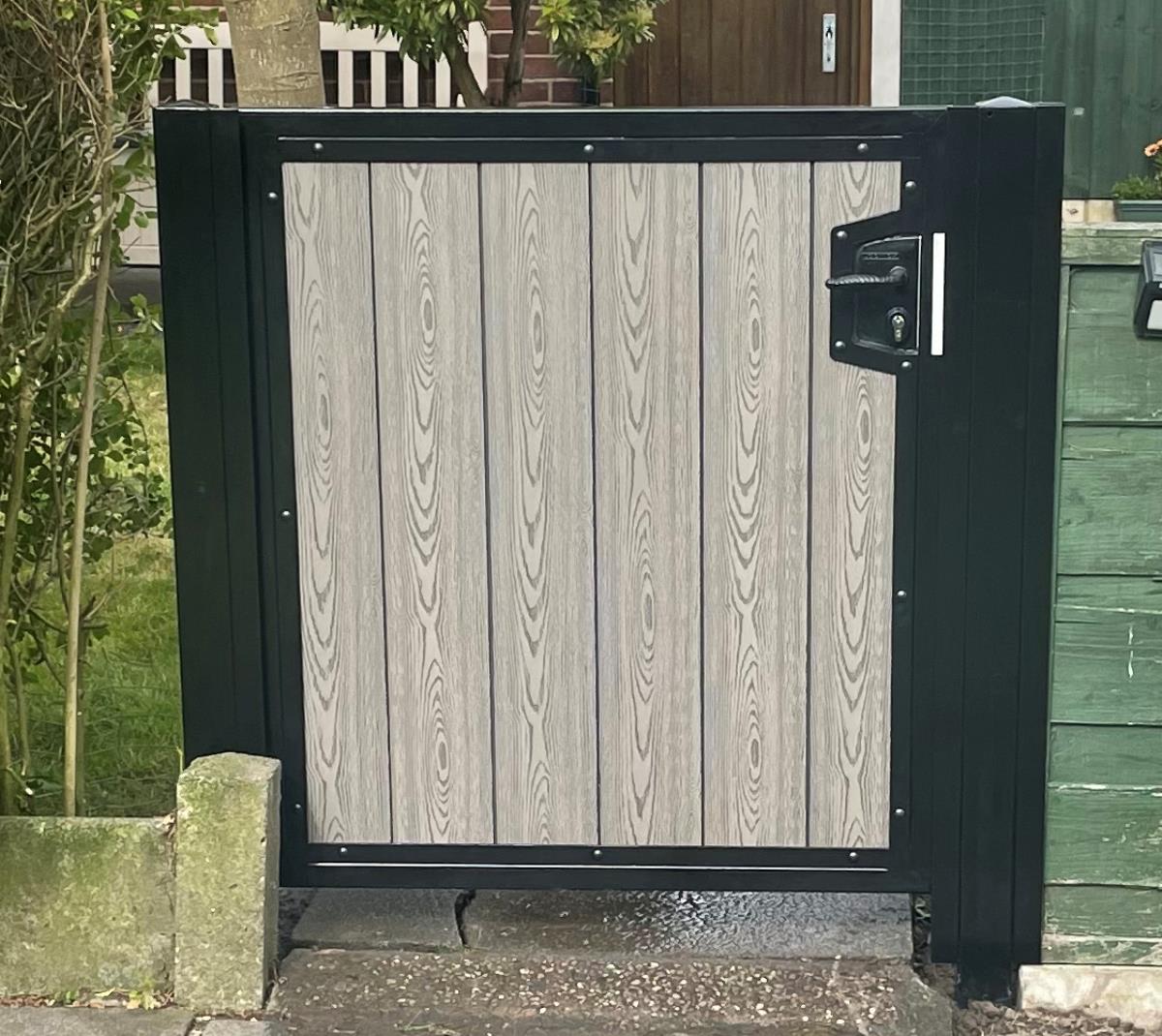 Composite gate with black timber effect infill fitted to the alley of home in the Manchester area.