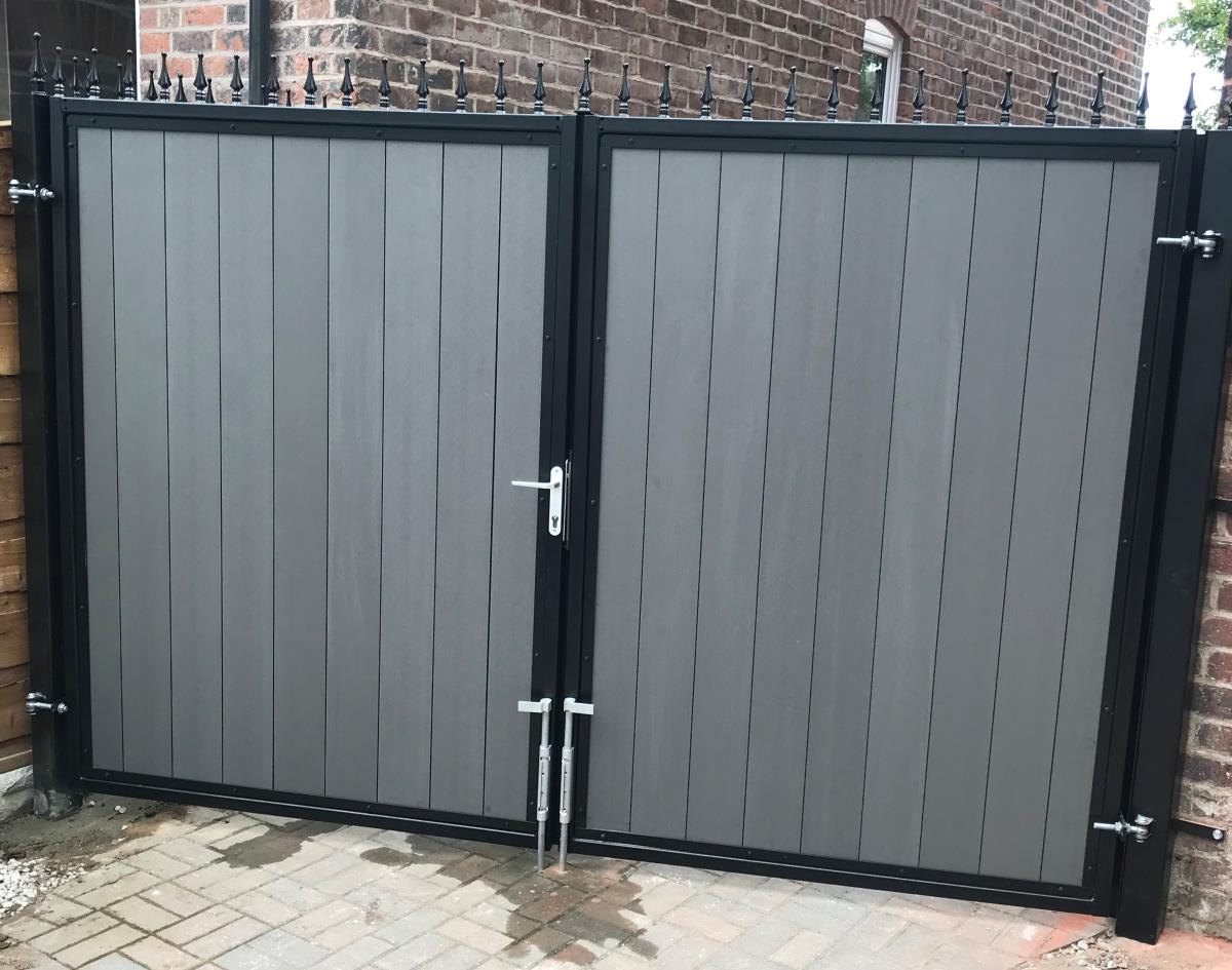 Double composite driveway gates and side gate with grey infill boards installed to a home in Manchester.