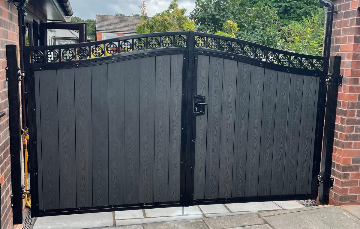 Ornate double arched composite gates with black embossed wood effect installed in Bolton area.