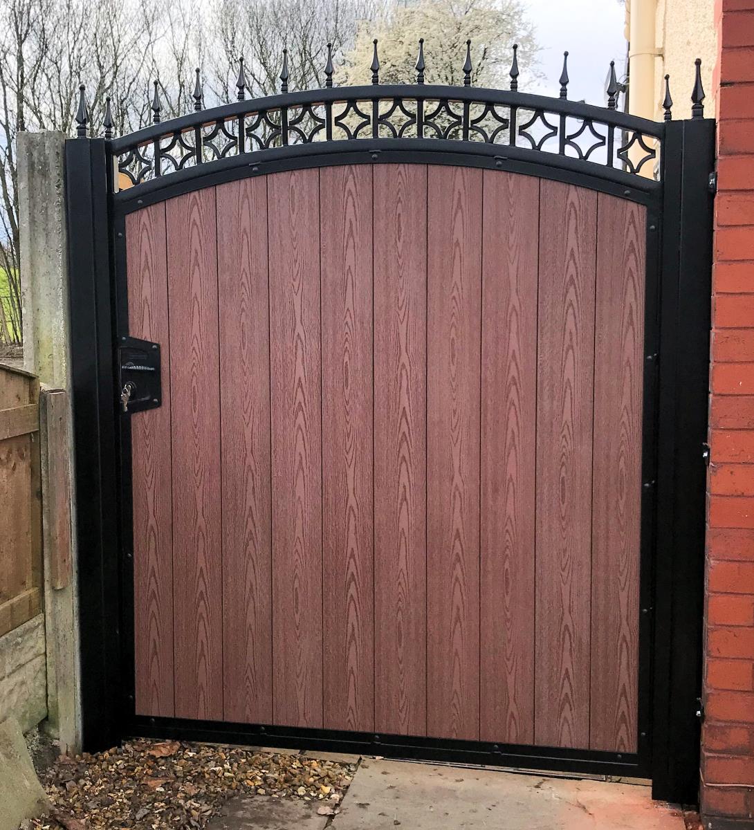 Ornate brown timber effect composite gate with integral locking system fitted in the Bolton area.