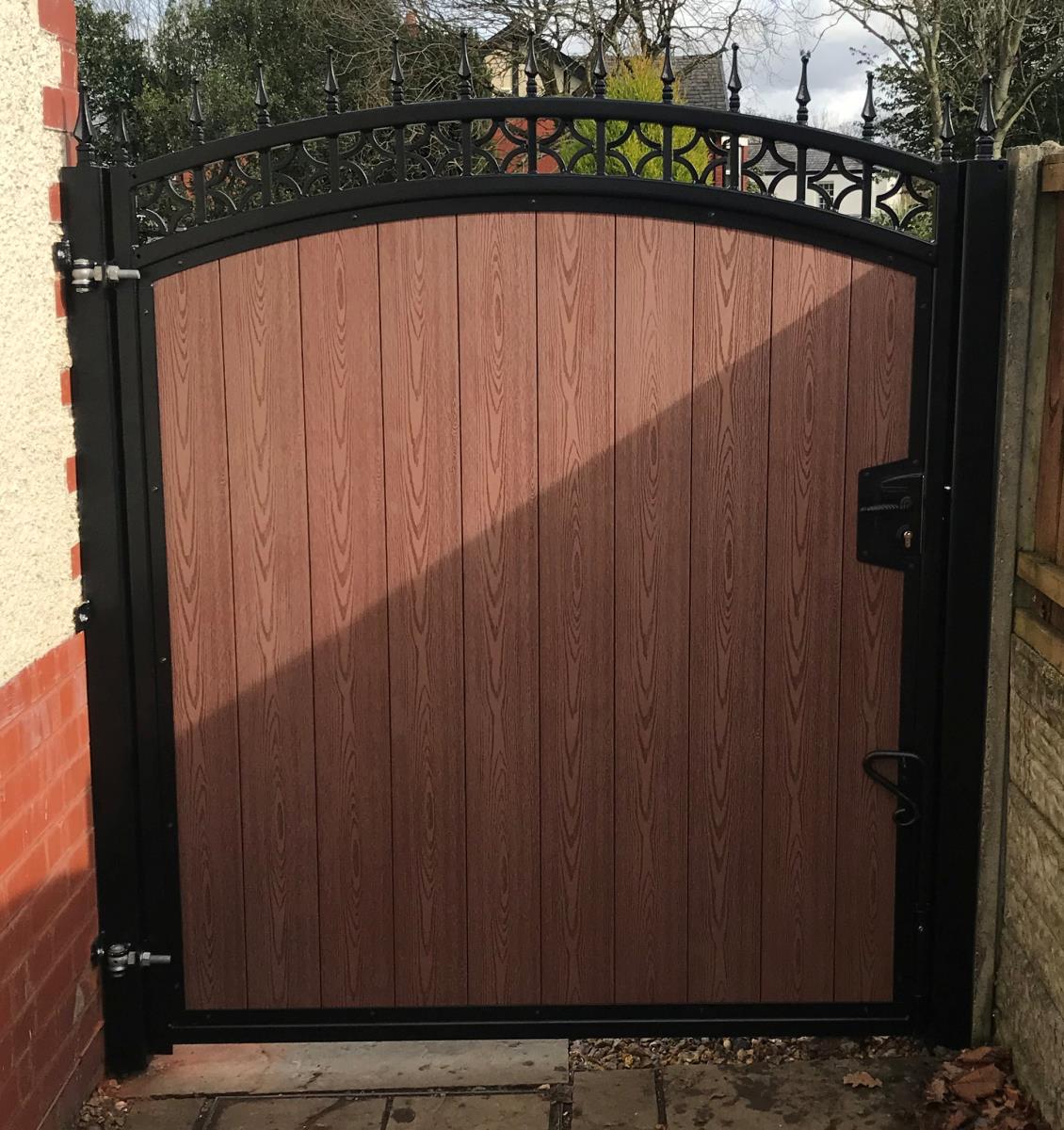 Ornate steel framed timber effect composite gate installation for a property in the Manchester area.