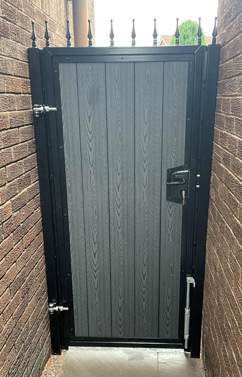 Black framed alley gate with antracite woodgrain composite infill installed in Liverpool.