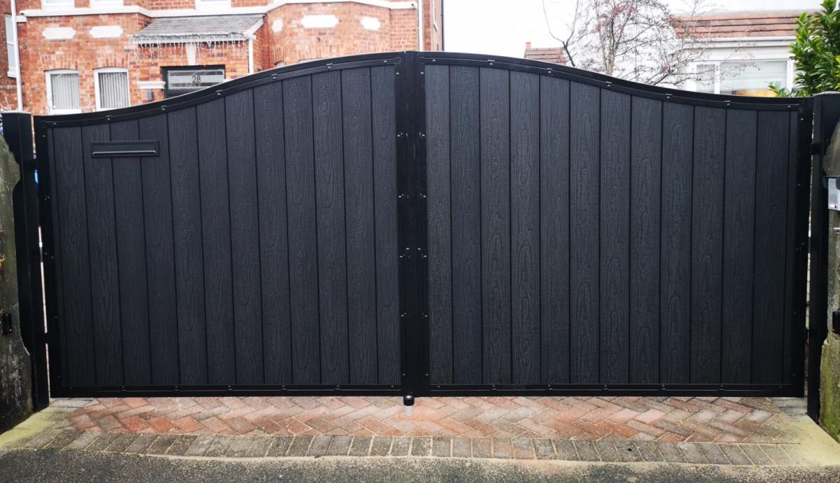 Arch top black composite electric gates in embossed timber infill style installed for a home in the Liverpool area.
