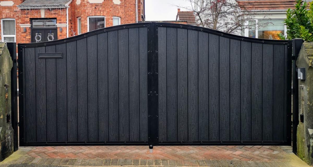 Black composite automated gates aith arched top in timber infill style installed to a home in the St Helens area.