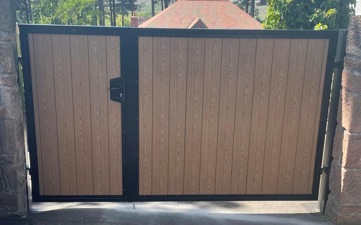 One and two thirds double driveway gates with composite infill in golden oak fitted at a home in Southport.
